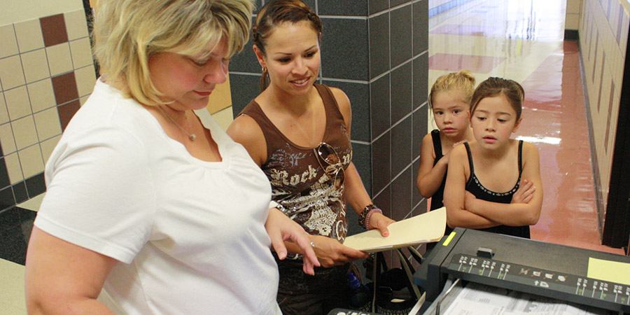 A parent registers her children A parent registers her children