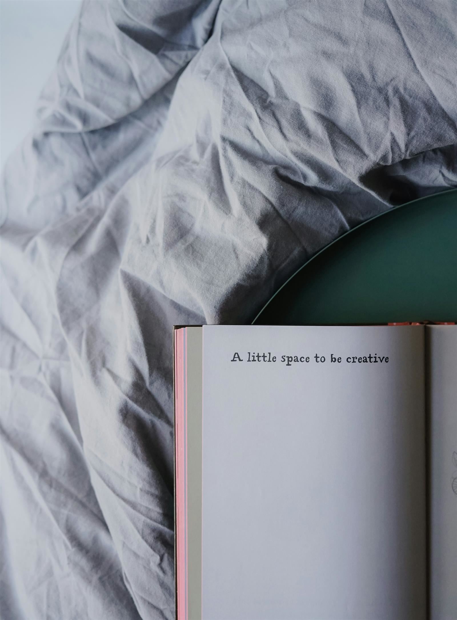 Image of an open book that says "A little space to be creative." 