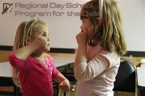 Two children signing 