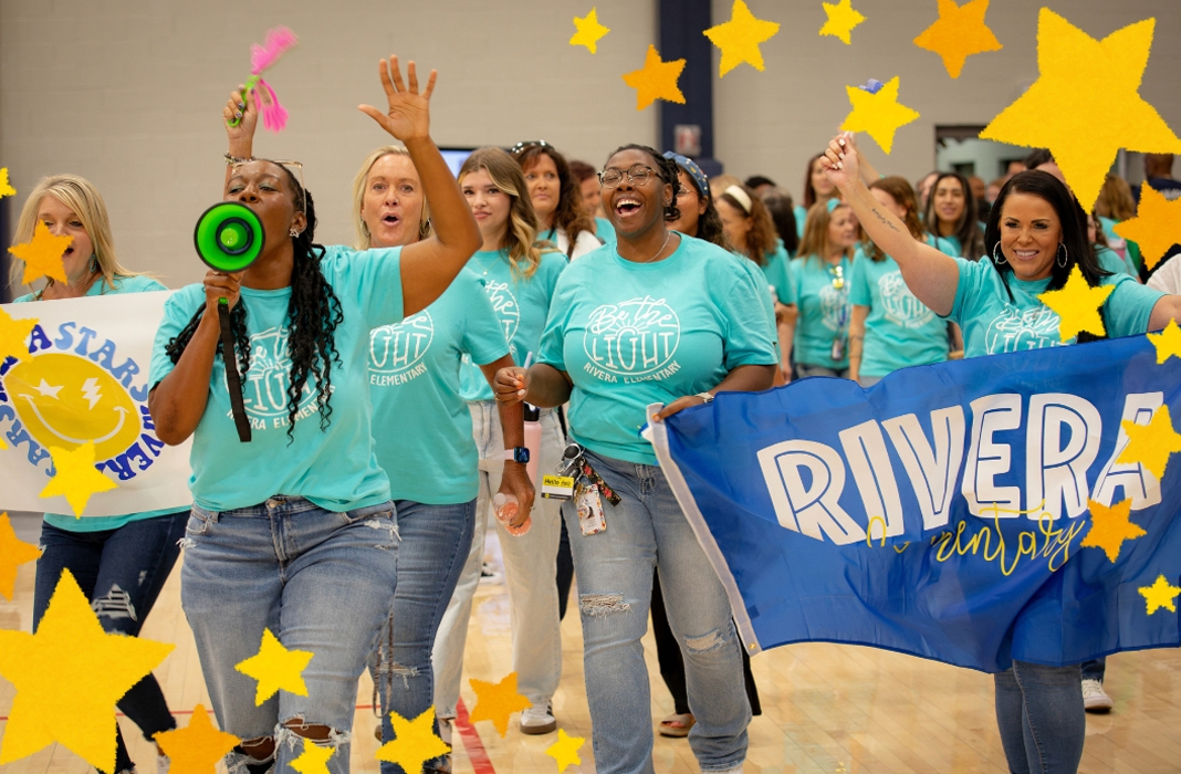 Staff posing with Rivera Sign