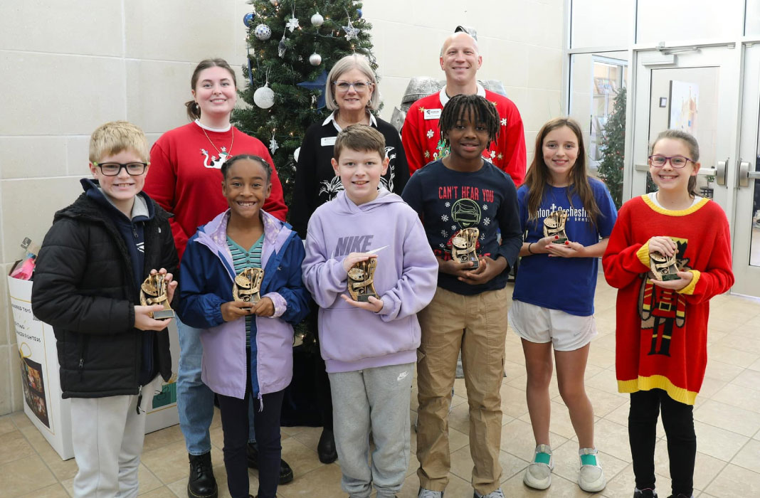 Students and staff with trophies